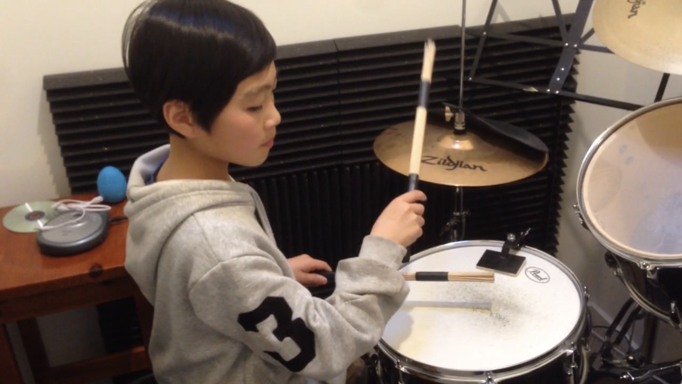 Young student proudly holding up their sheet music