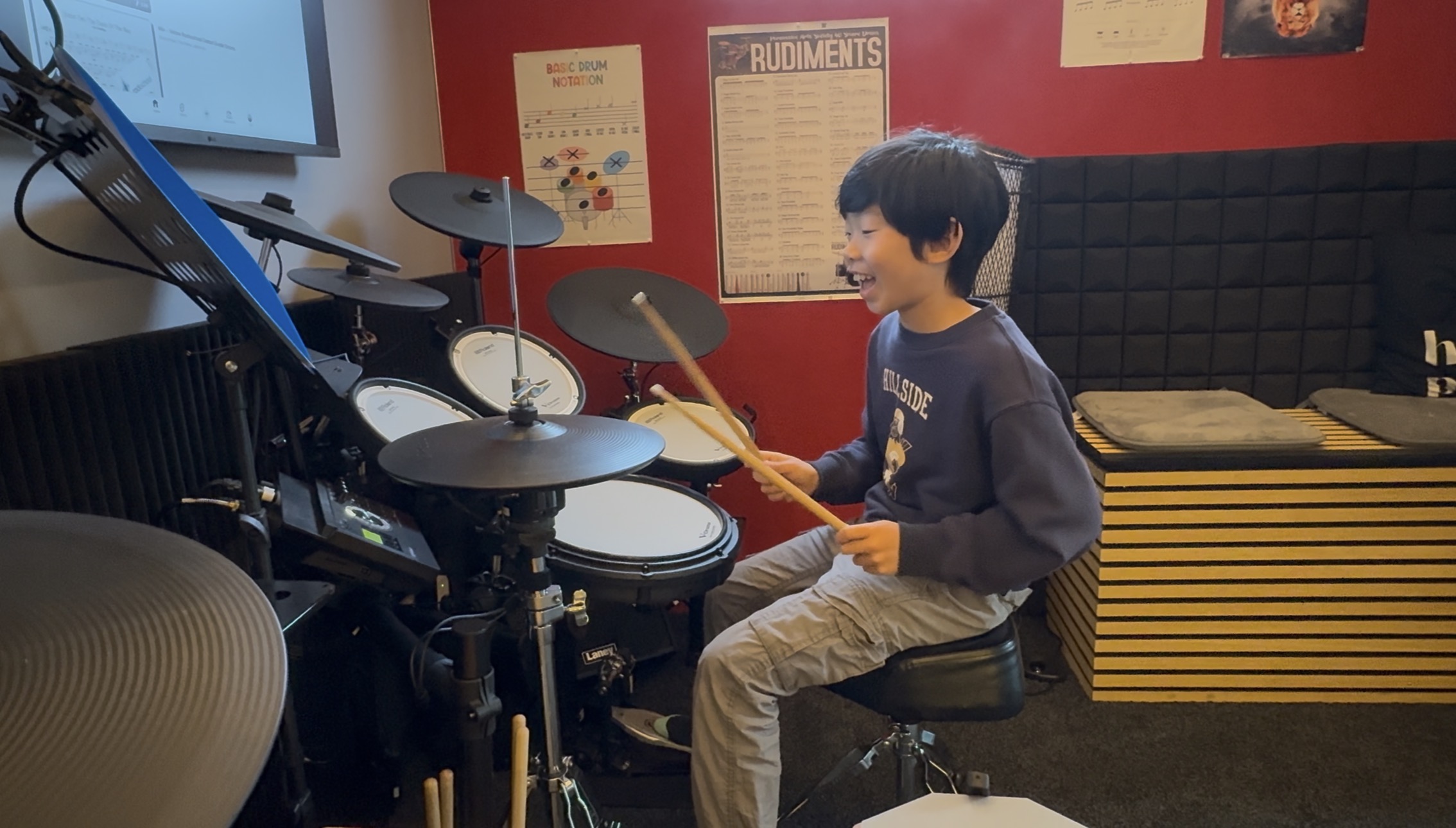 Student mid-lesson, learning a new drumming technique