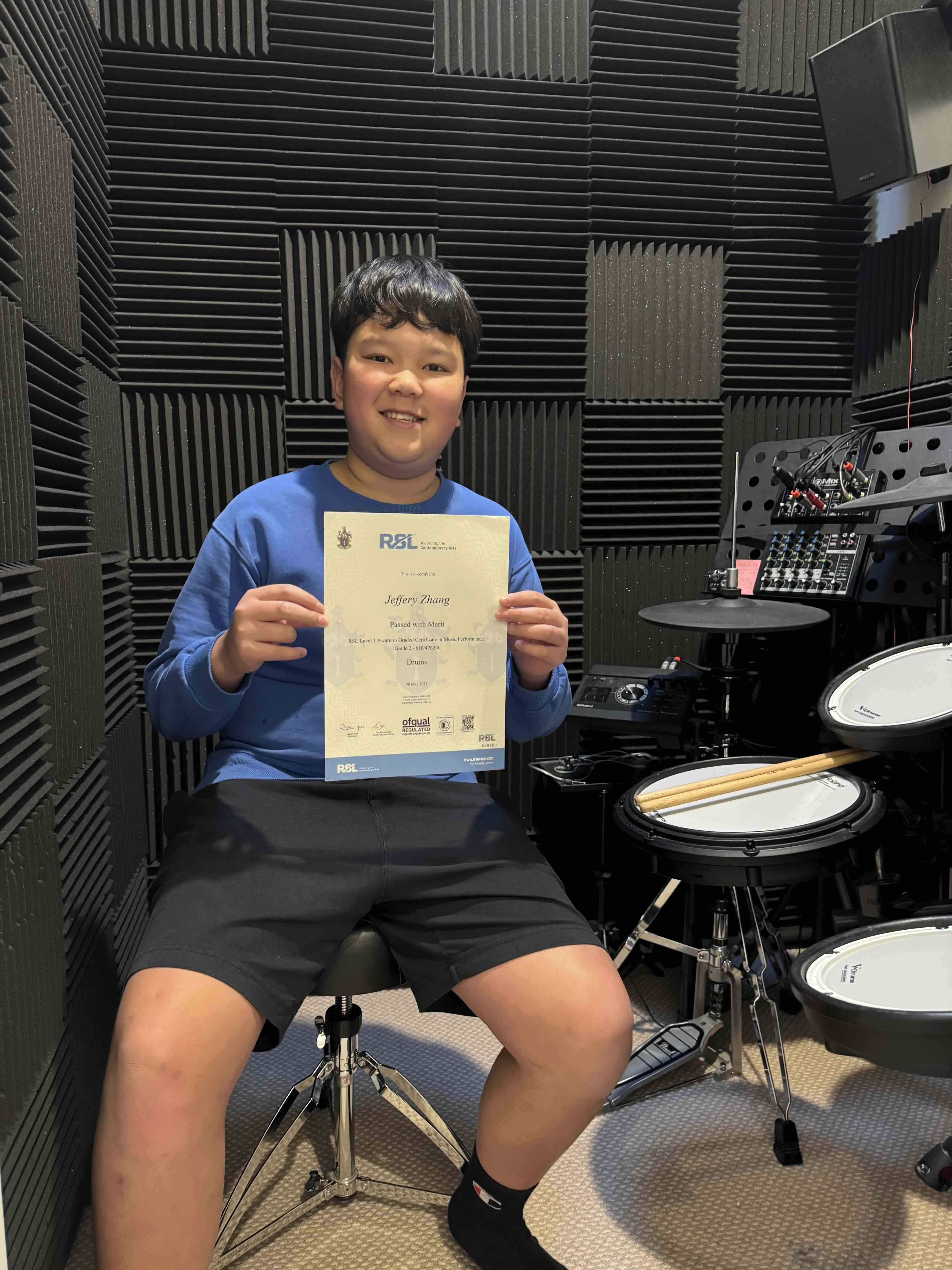Student concentrating while playing the drums